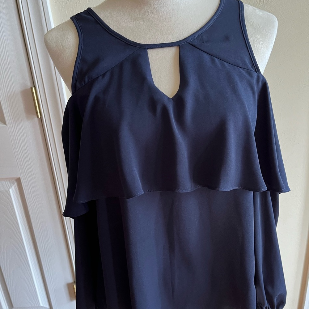 Navy blouse with cold shoulder long sleeves and cut out detail on the front.